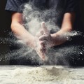 Clap hands of baker with flour in restaurant kitchen